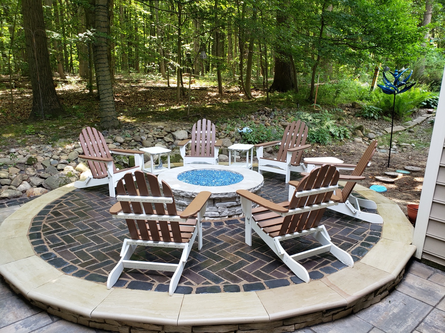 A fire pit with chairs around it

Description automatically generated